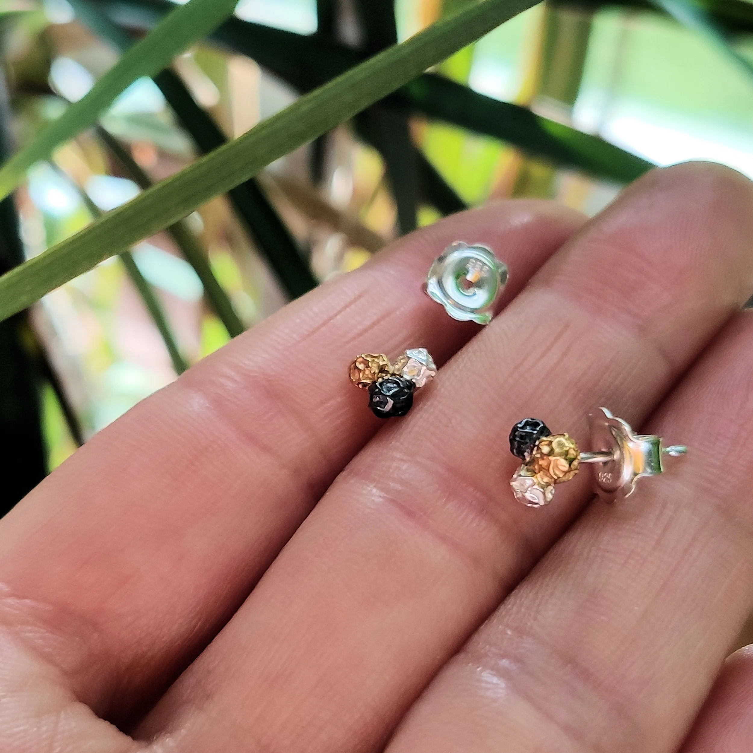 A silver three colours peppercorn stud earrings