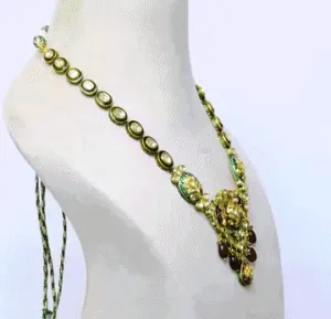 Capture the majestic charm of the peacock with our enchanting Meena necklace, embellished with sparkling diamond polki and vibrant ruby hangings(KNNE3400)