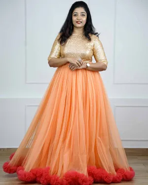 Peach and Coral pink net gown with golden sequins yoke